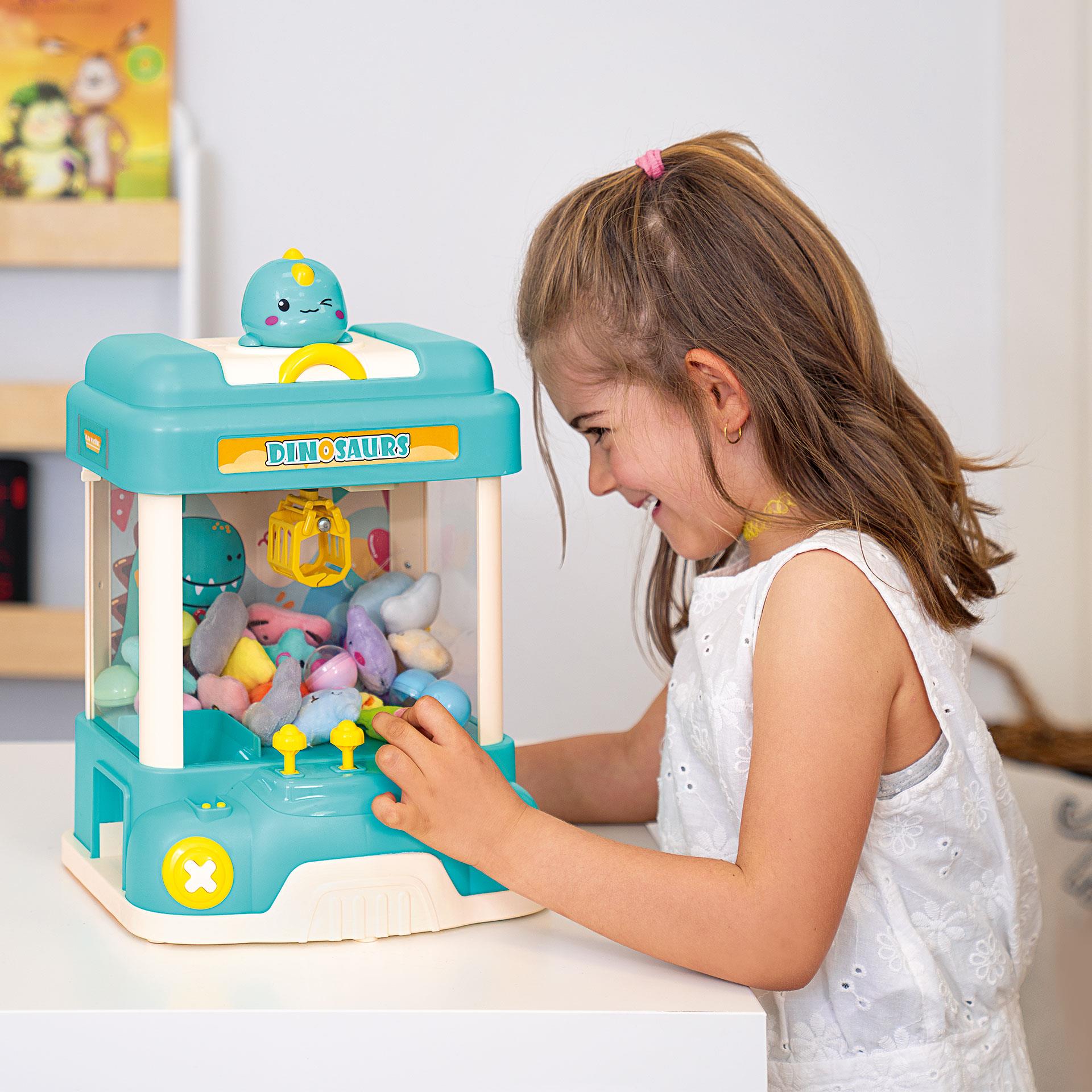 Spielzeug-Greifautomat im Dino-Look mit bunten Dino-Plüschtieren und Überraschungskugeln zum Greifen